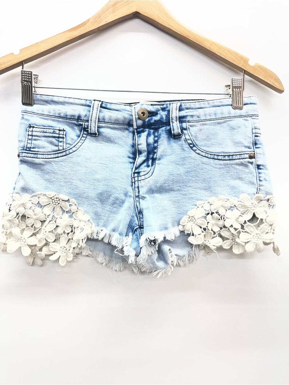 Kiss & Cry denim‎ shorts with white floral lace applique details.